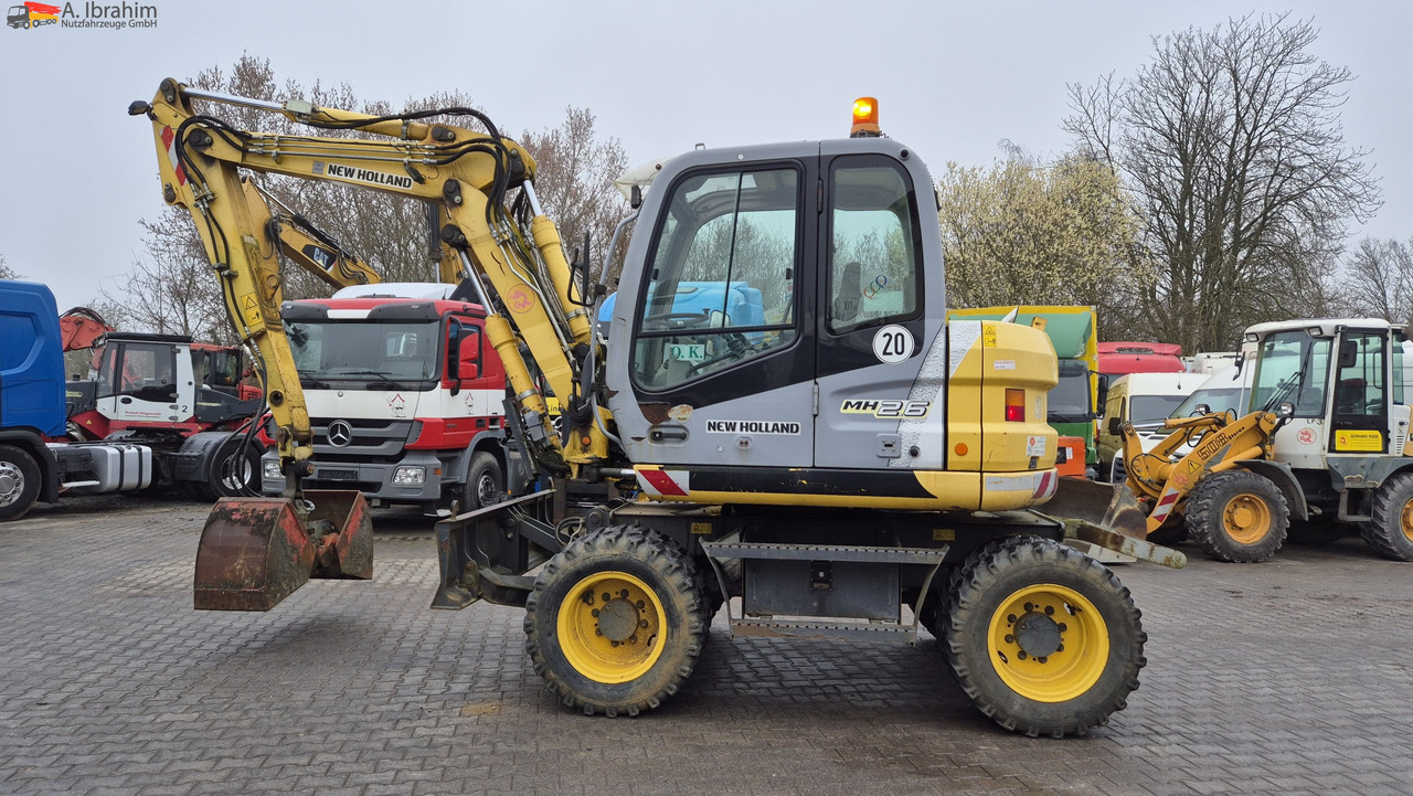 New Holland MH 2.6 Zustand gut, deutsche Maschine incl. Greifer und Dreservo - Wheel excavator: picture 1 New Holland MH 2.6 Zustand gut, deutsche Maschine incl. Greifer und Dreservo - Wheel excavator: picture 1
